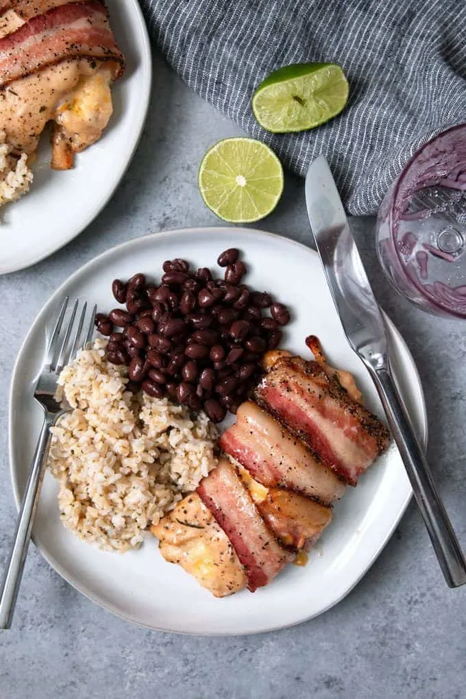 picture of cilantro lime chicken wrapped in bacon with beans and rice