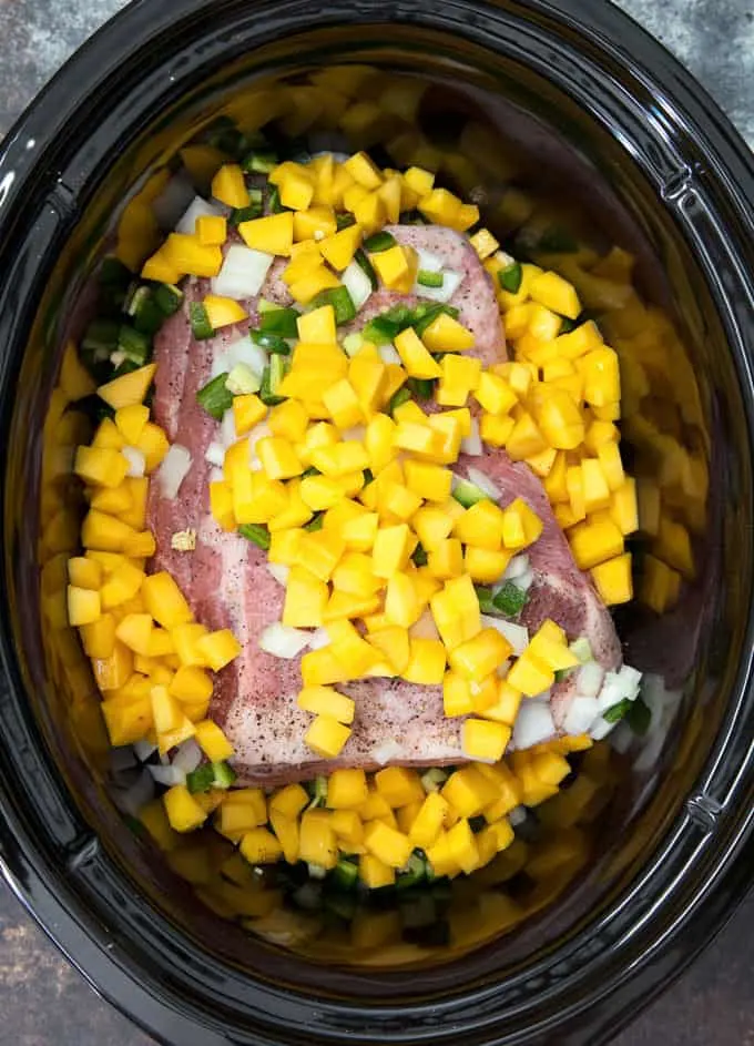 mango pulled pork ingredients in a slow cooker