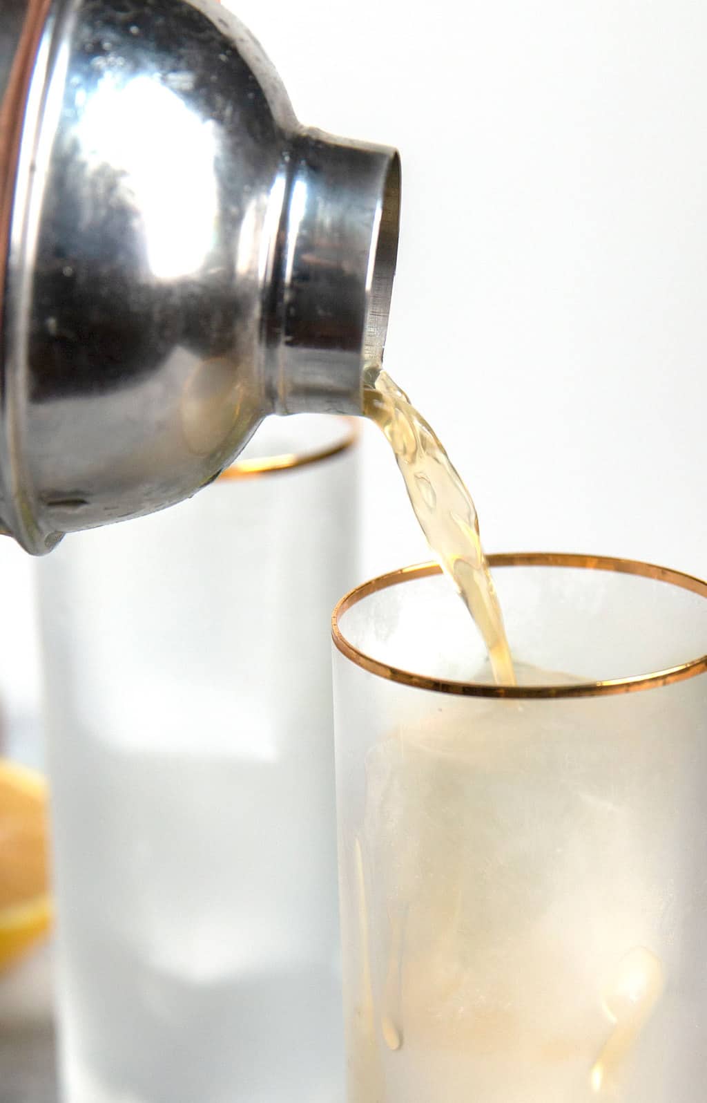 closeup photo of bourbon being poured into a glass