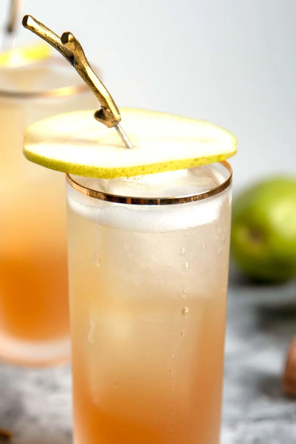 one sparkling bourbon pear cocktail with a pear garnish