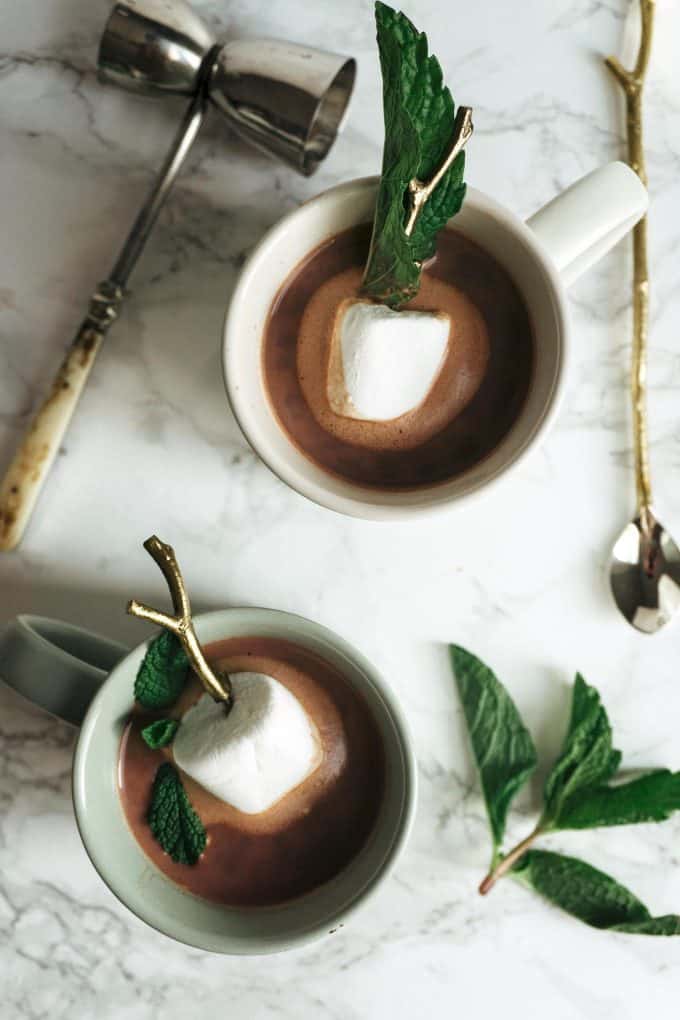 overhead photo of two cups of boozy mint hot chocolate 