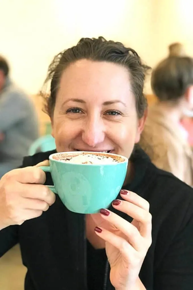 Jenny drinking a mug of hot chocolate