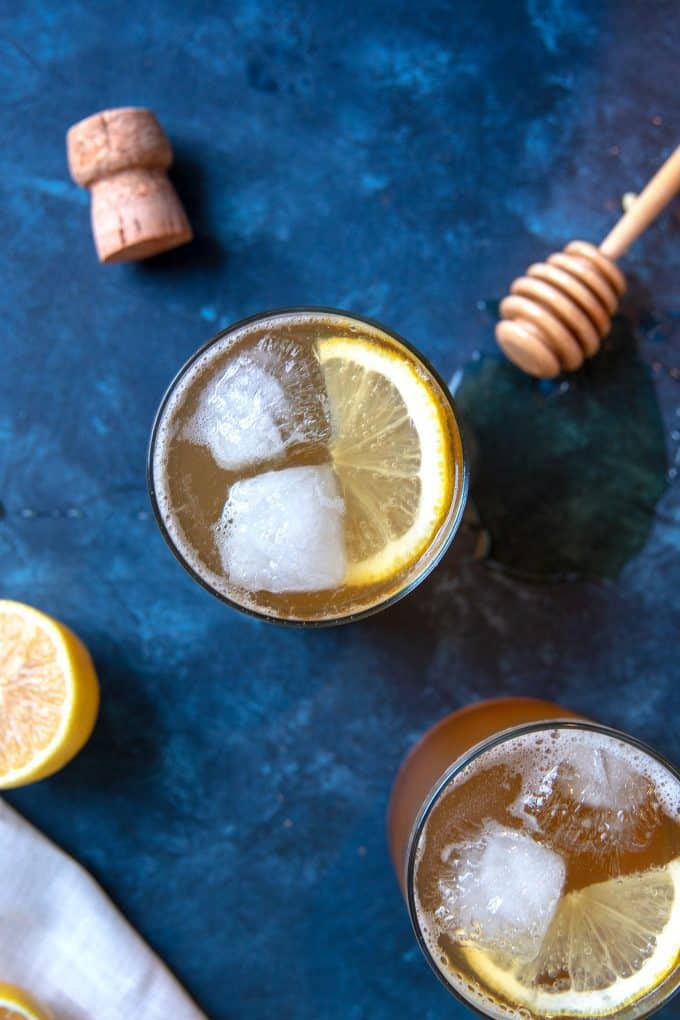 two sparkling honey rye whiskey cocktails and a wine cork