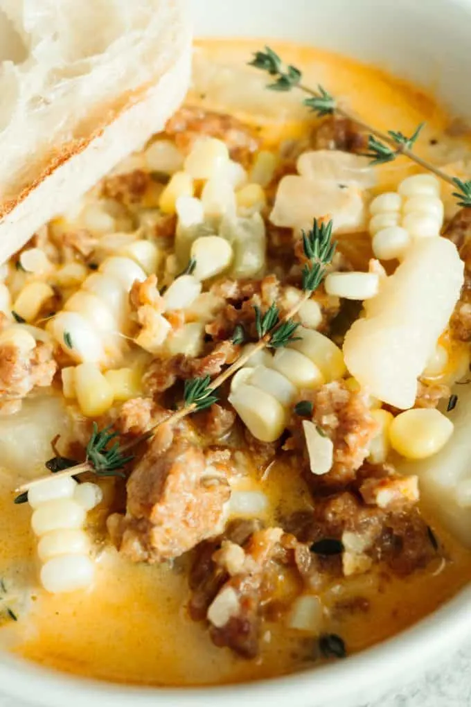 close up photo of spicy sausage corn chowder in a white bowl