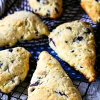baking rack with multiple blueberry chocolate chip scones.