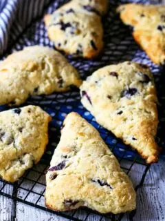 baking rack with multiple blueberry chocolate chip scones.