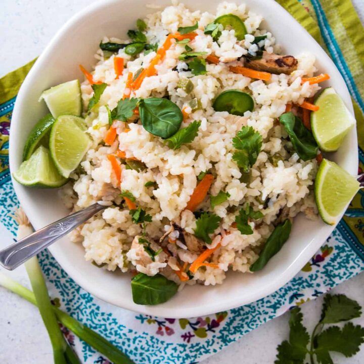 one pot spicy Thai rice in a white bowl on top of a colored napkin
