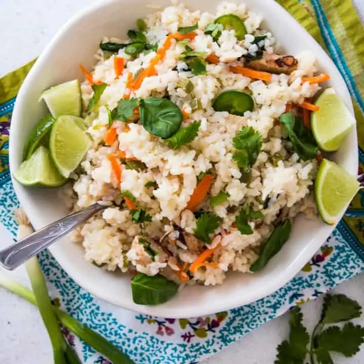 one pot spicy Thai rice in a white bowl on top of a colored napkin