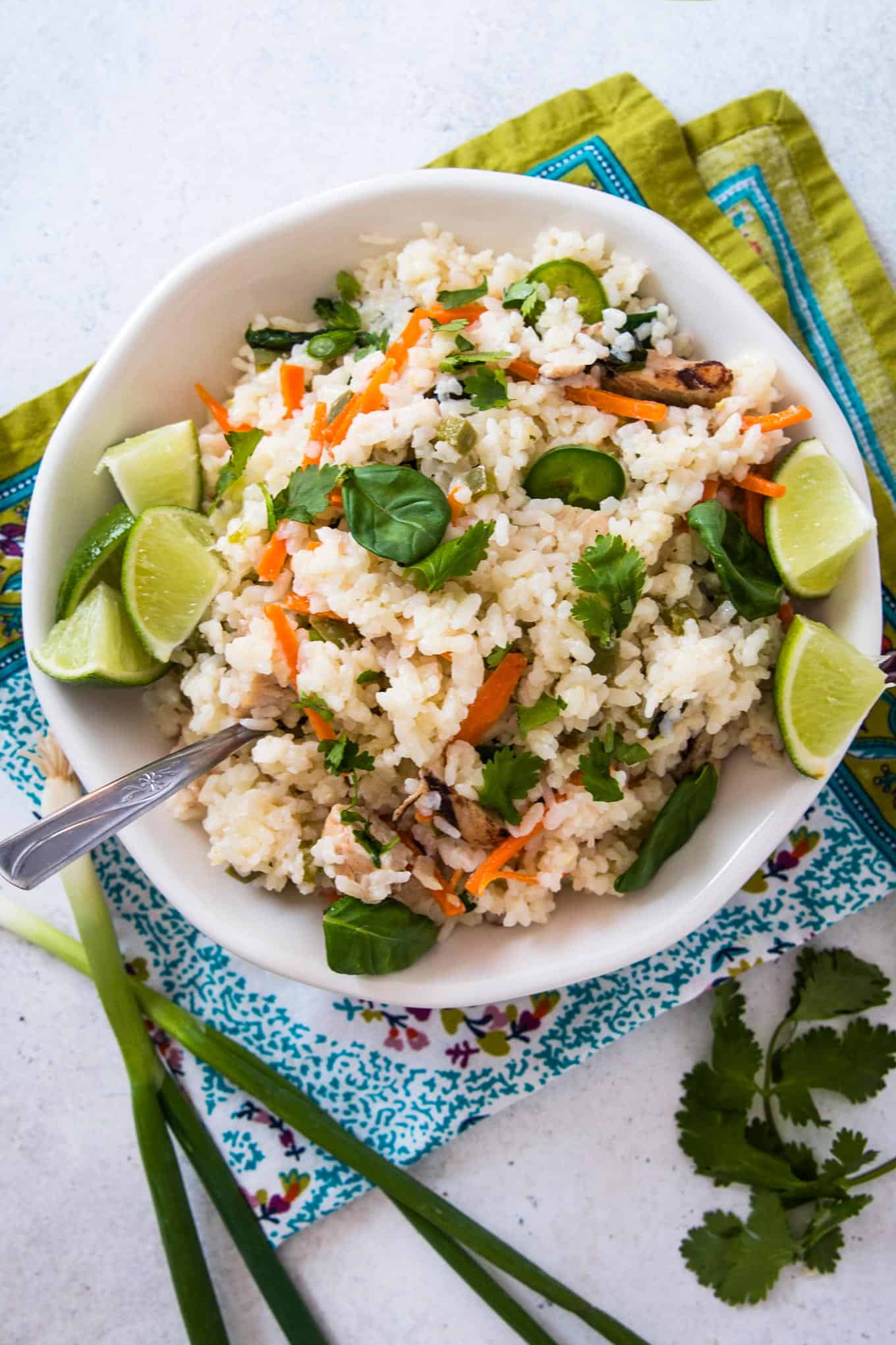 one pot spicy Thai rice in a white bowl on top of a colored napkin