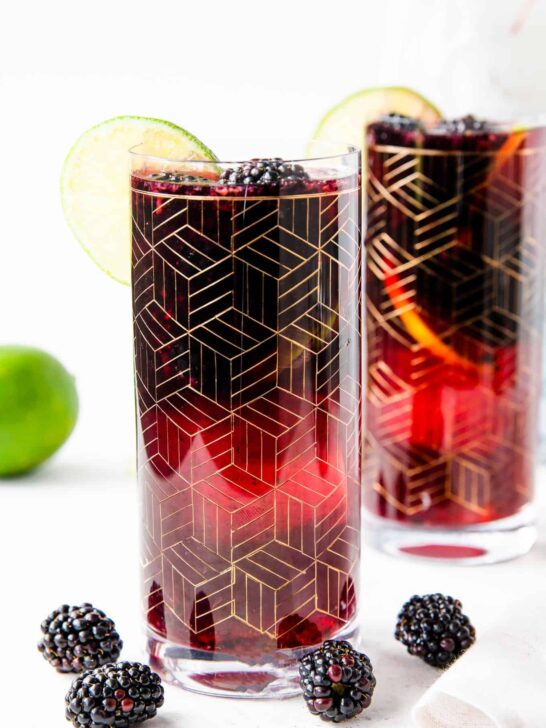 two gold etched glasses of blackberry sangria