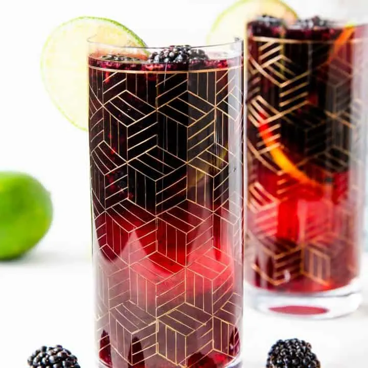 two gold etched glasses of blackberry sangria