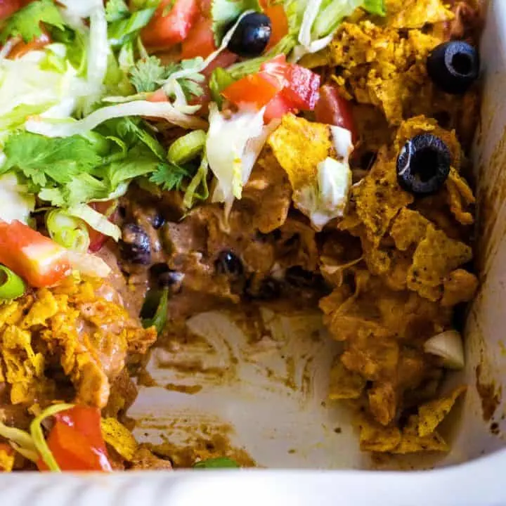 chicken taco casserole in a white casserole dish