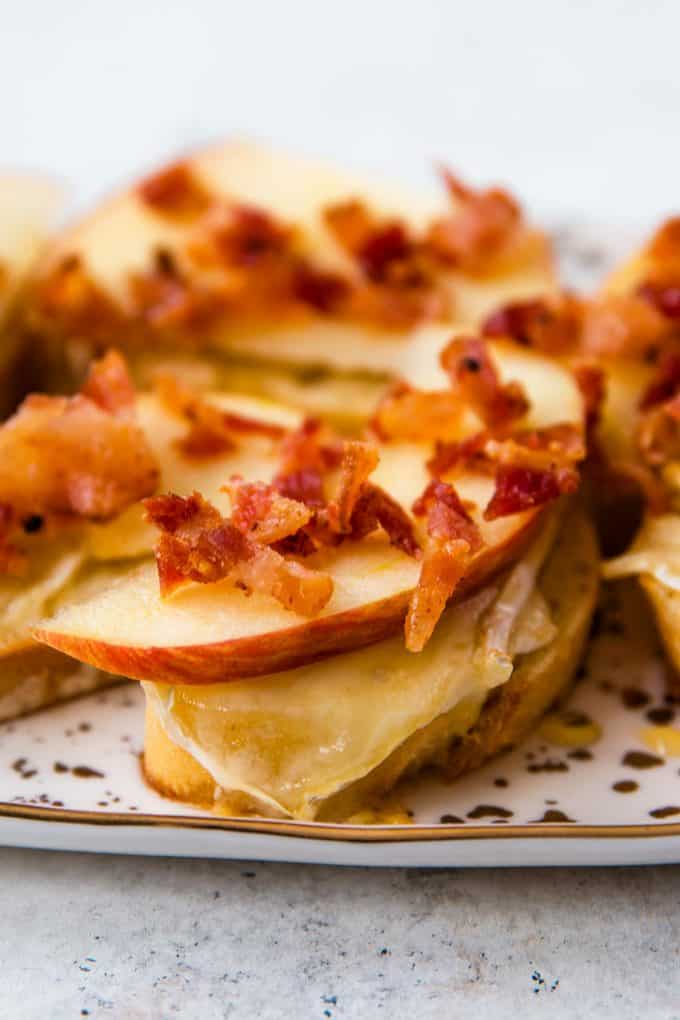 crumbled bacon on top of apple and melted brie on crostini