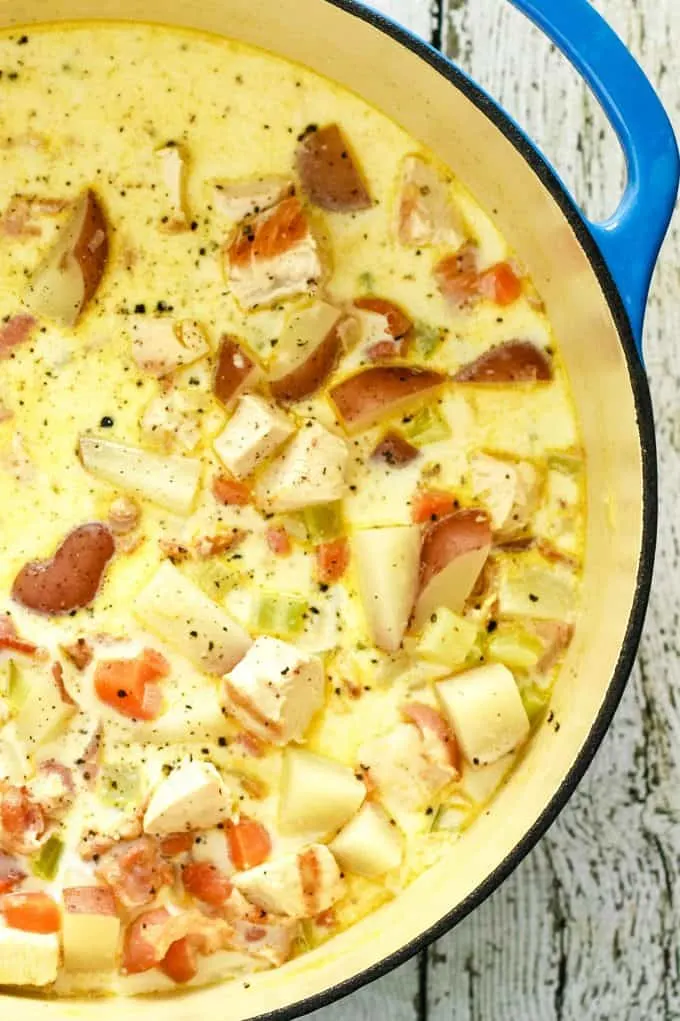 blue dutch oven of chicken potato chowder