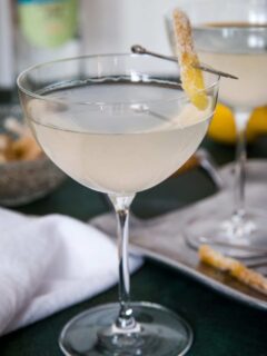 single gin ginger martini garnished with candied ginger