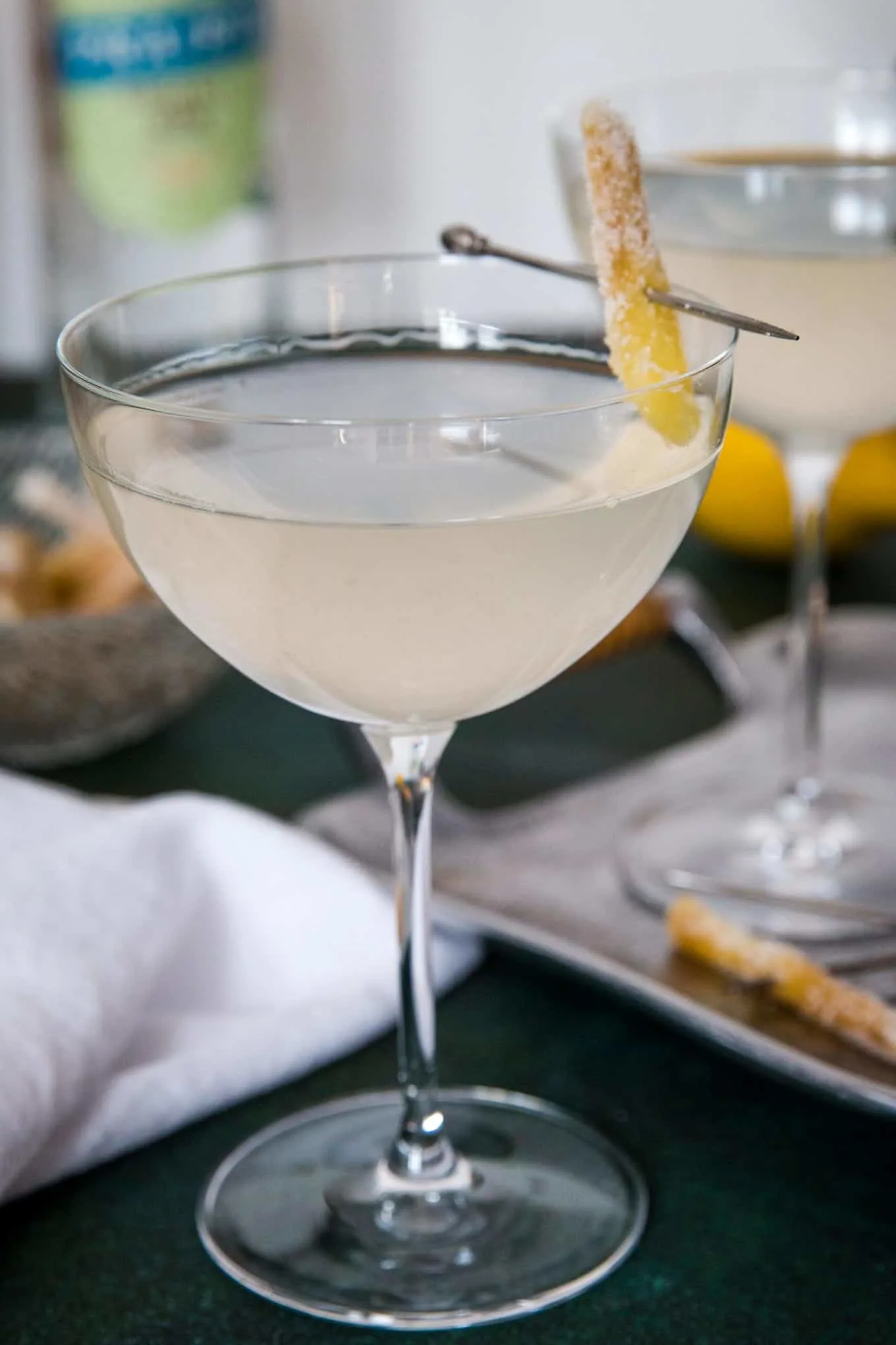 single gin ginger martini garnished with candied ginger