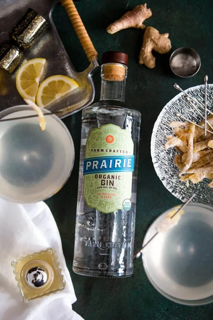 two gin ginger martinis a bottle of Prairie Organic Spirits gin and garnishes