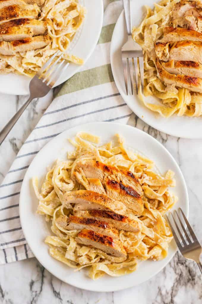 three plates of creamy chicken tagliatelle