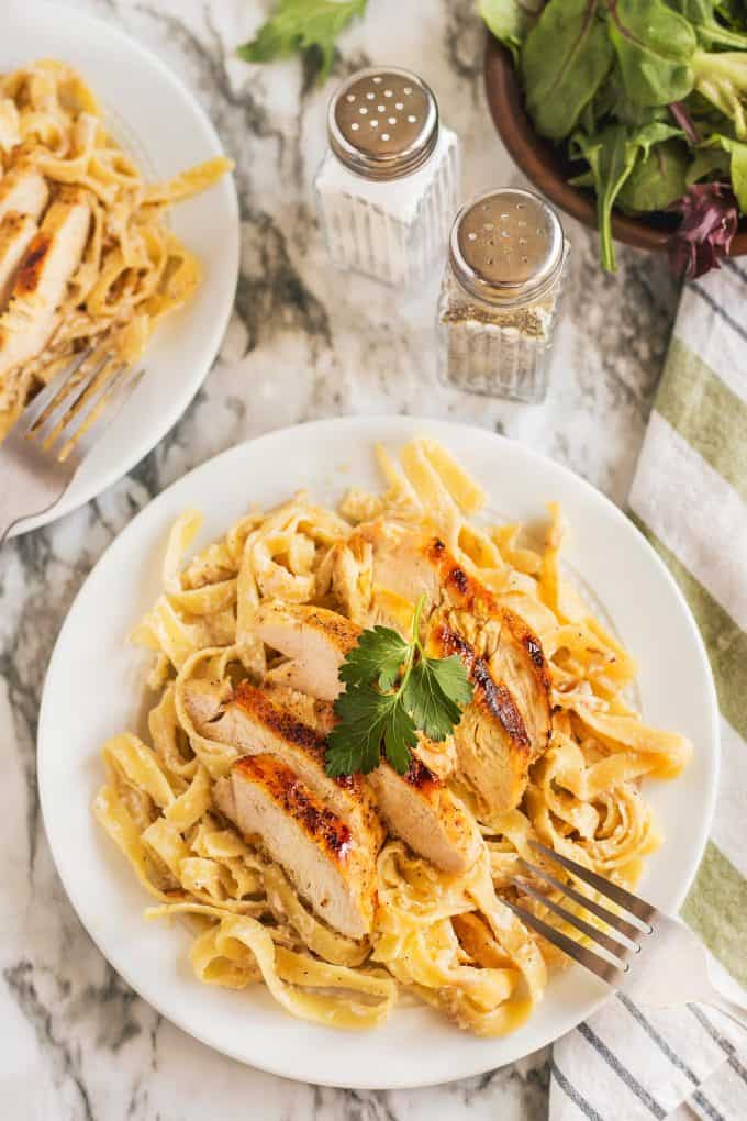 garnished chicken tagliatelle pasta recipe, a fork is ready to swirl the pasta 