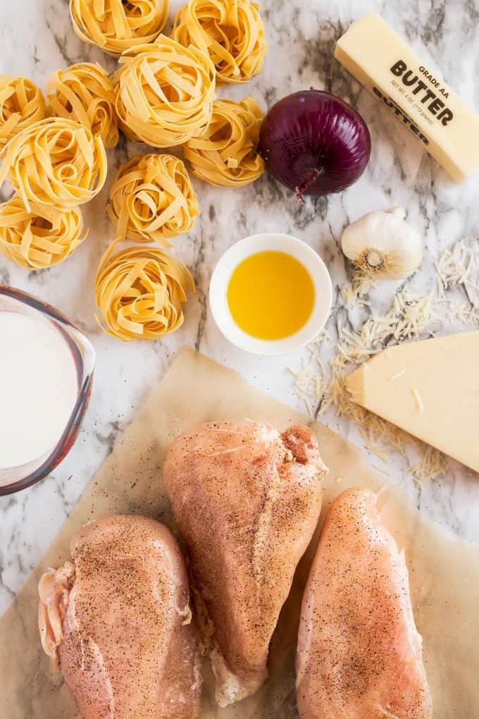 chicken tagliatelle ingredients including raw chicken oil, cream, and parmesan