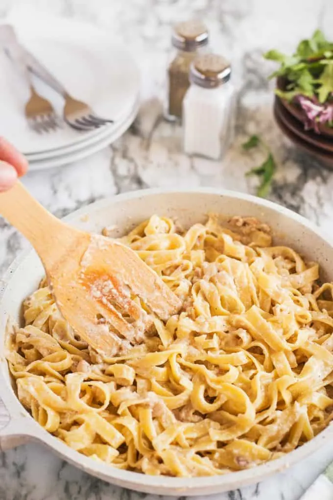 creamy chicken tagliatelle with a wooden spoon