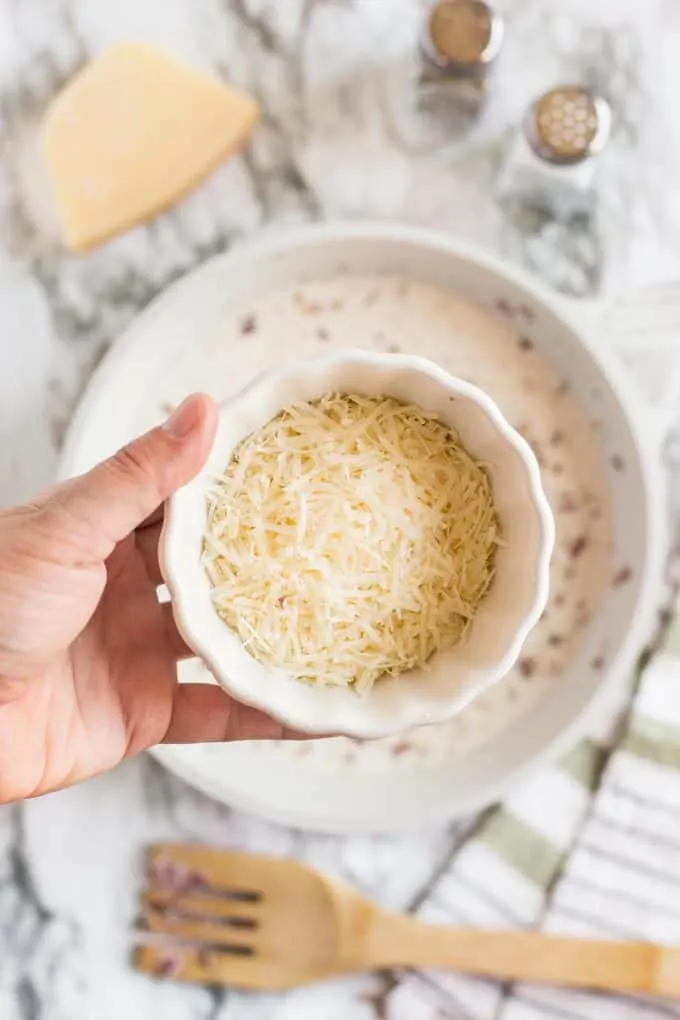 parmesan cheese in a ramekin, about to be added to the sauce for creamy tagliatelle