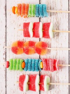 5 assembled candy kabobs on wooden skewers