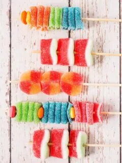 5 assembled candy kabobs on wooden skewers
