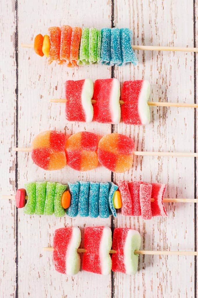 5 assembled candy kabobs on wooden skewers