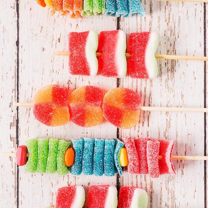 5 assembled candy kabobs on wooden skewers