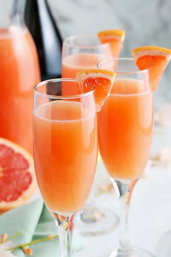 forward facing photo of grapefruit mimosas garnished with fresh grapefruit