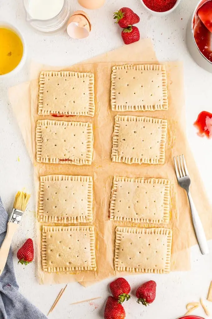 using a fork to press the edges of the dough together and poking holes into the tops of each pop tart