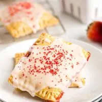 two strawberry pop tarts on a white plate