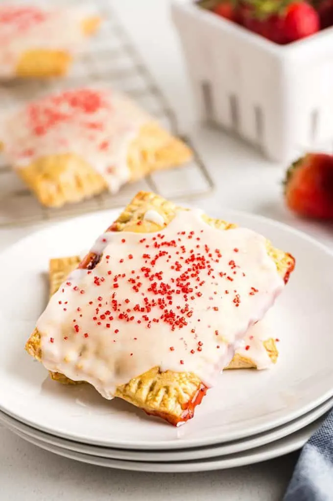 two strawberry pop tarts on a white plate
