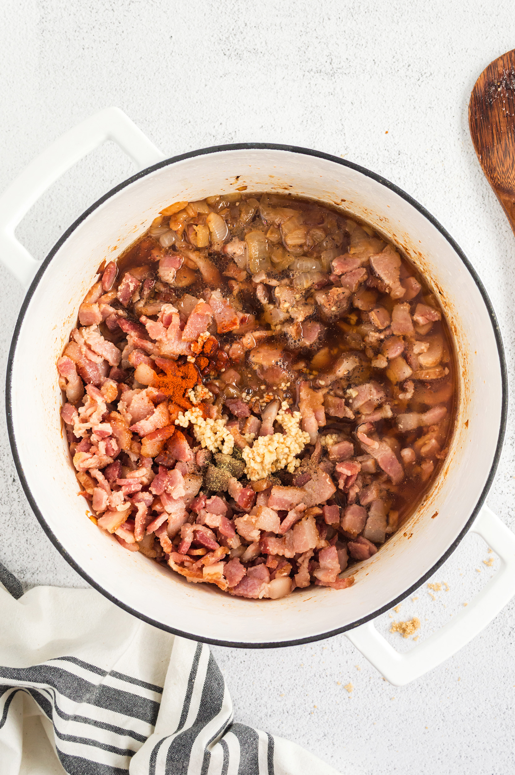 caramelized onions and bacon with the remaining ingredients in a large pot, ready to be cooked and combined