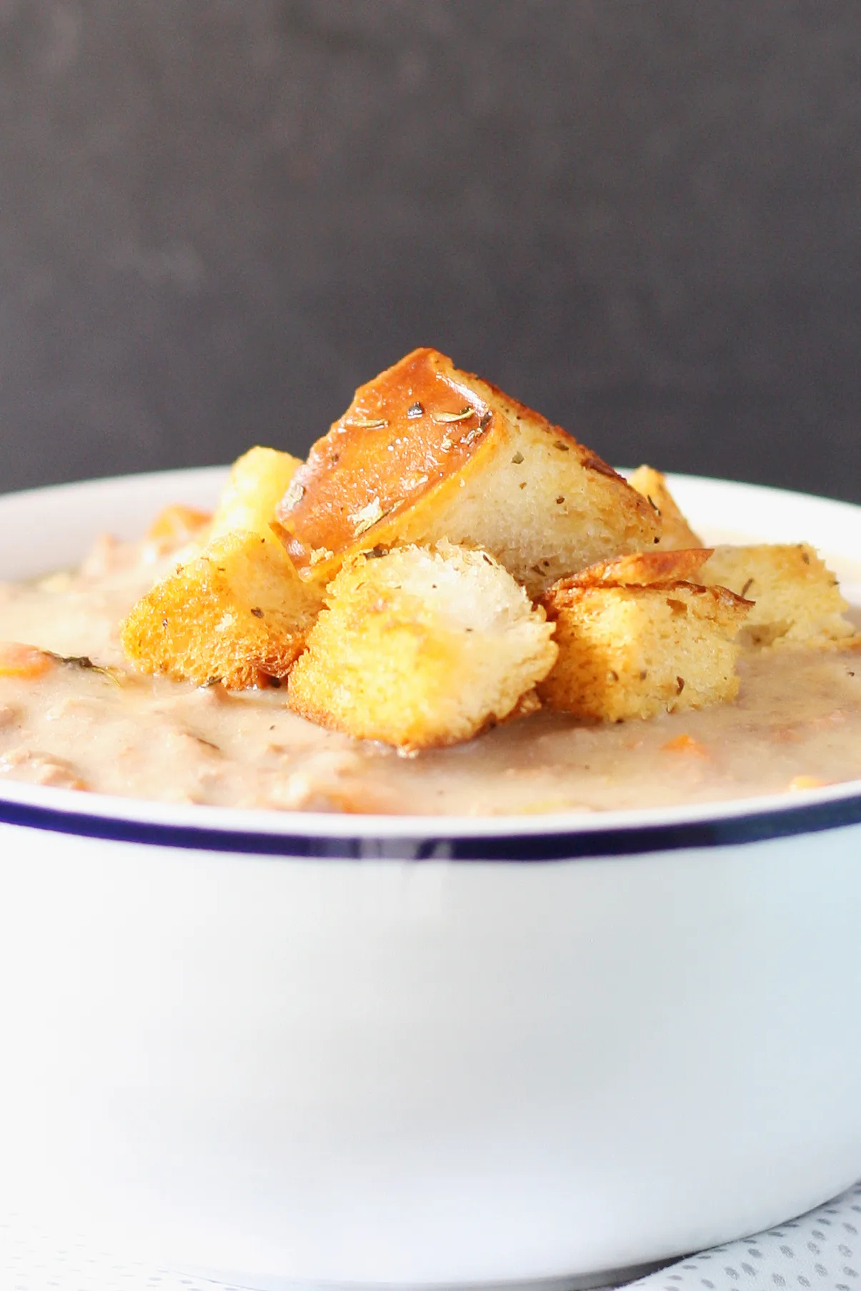 a bowl of thick soup topped with homemade croutons