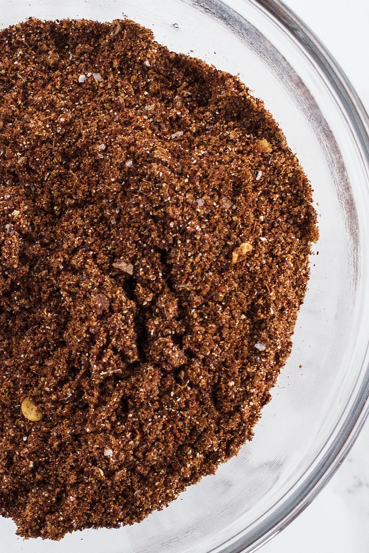 closeup photo of taco seasoning in a clear glass bowl