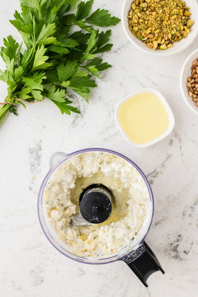 greek feta dip has been pulsed in a food processor and is just mixed until the ingredients have combined