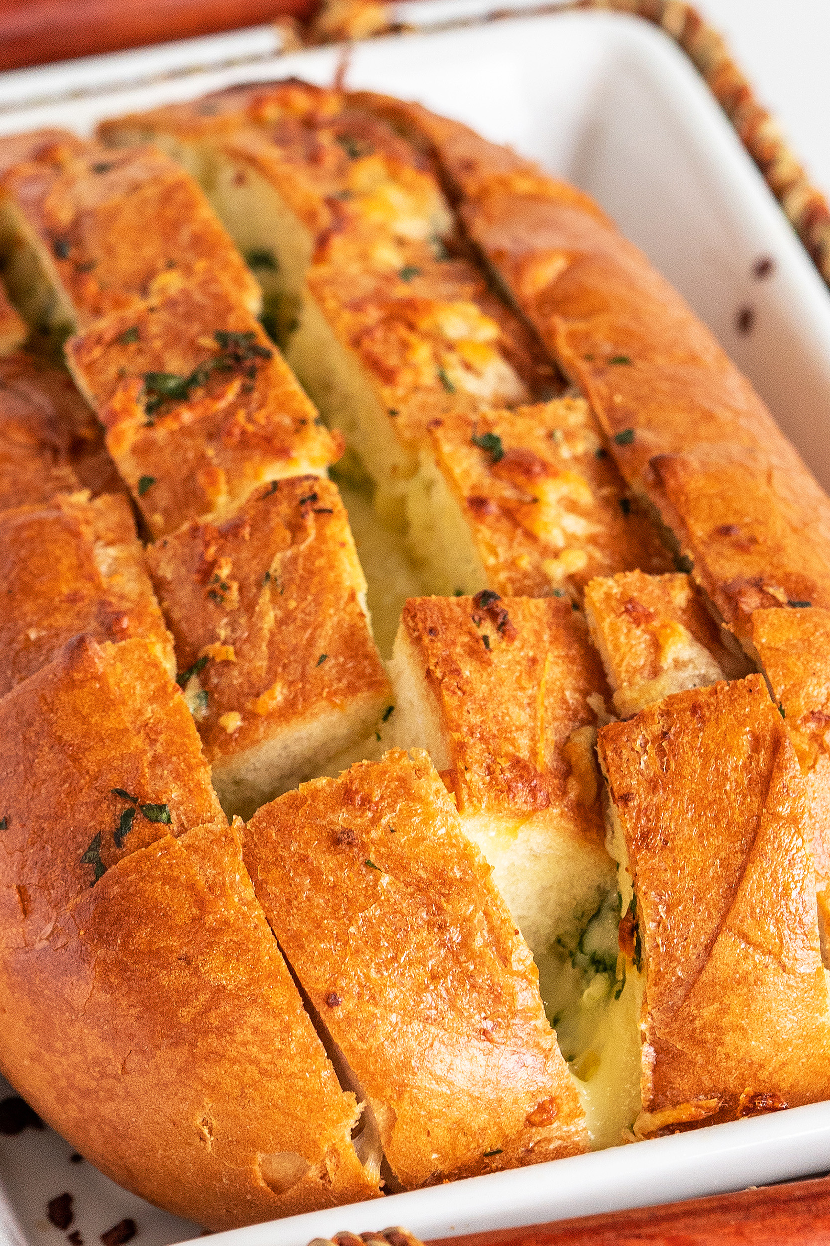 baked cheesy garlic pull apart bread in a baking dish