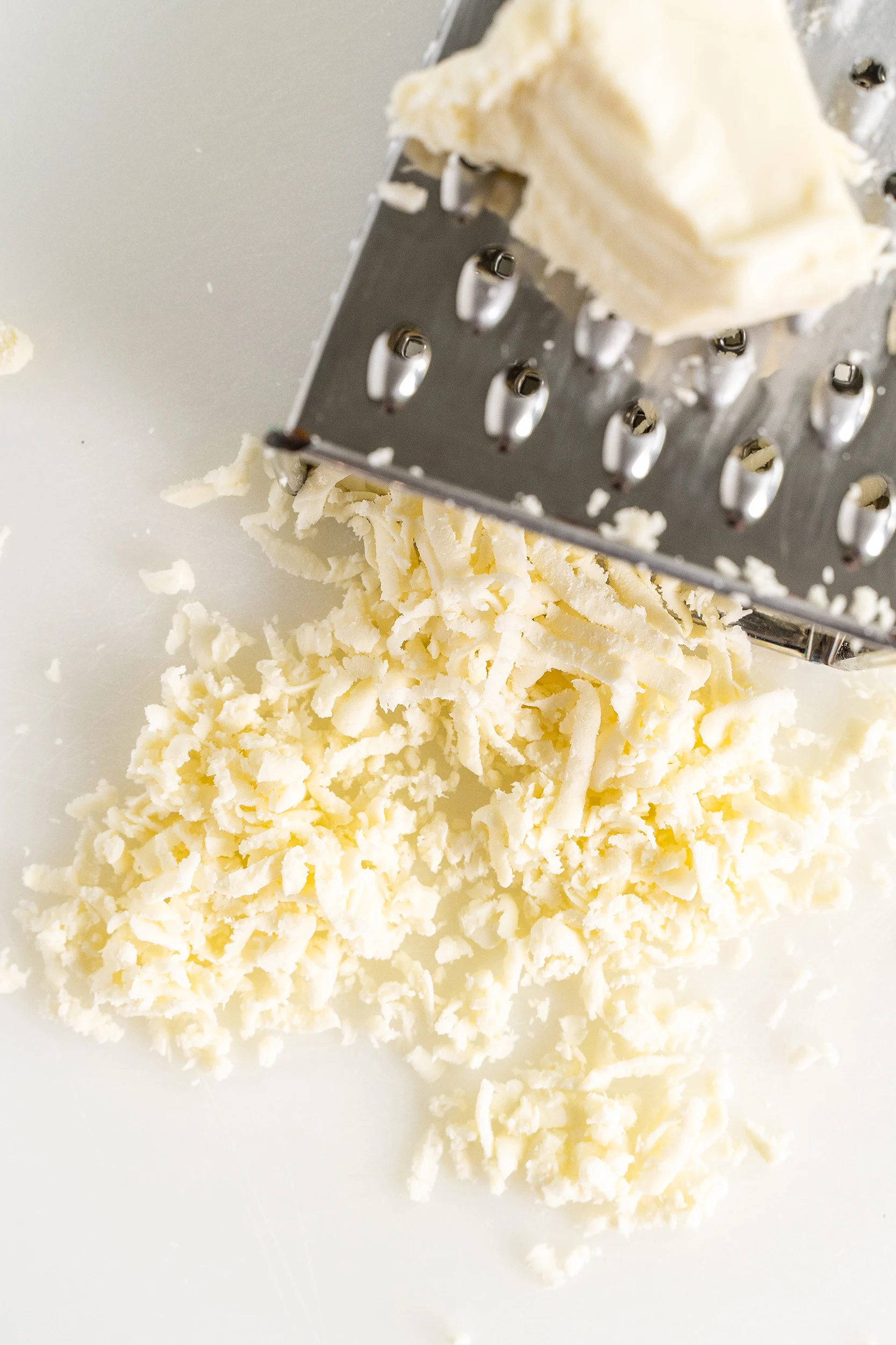 shredded mozzarella cheese and a box grater