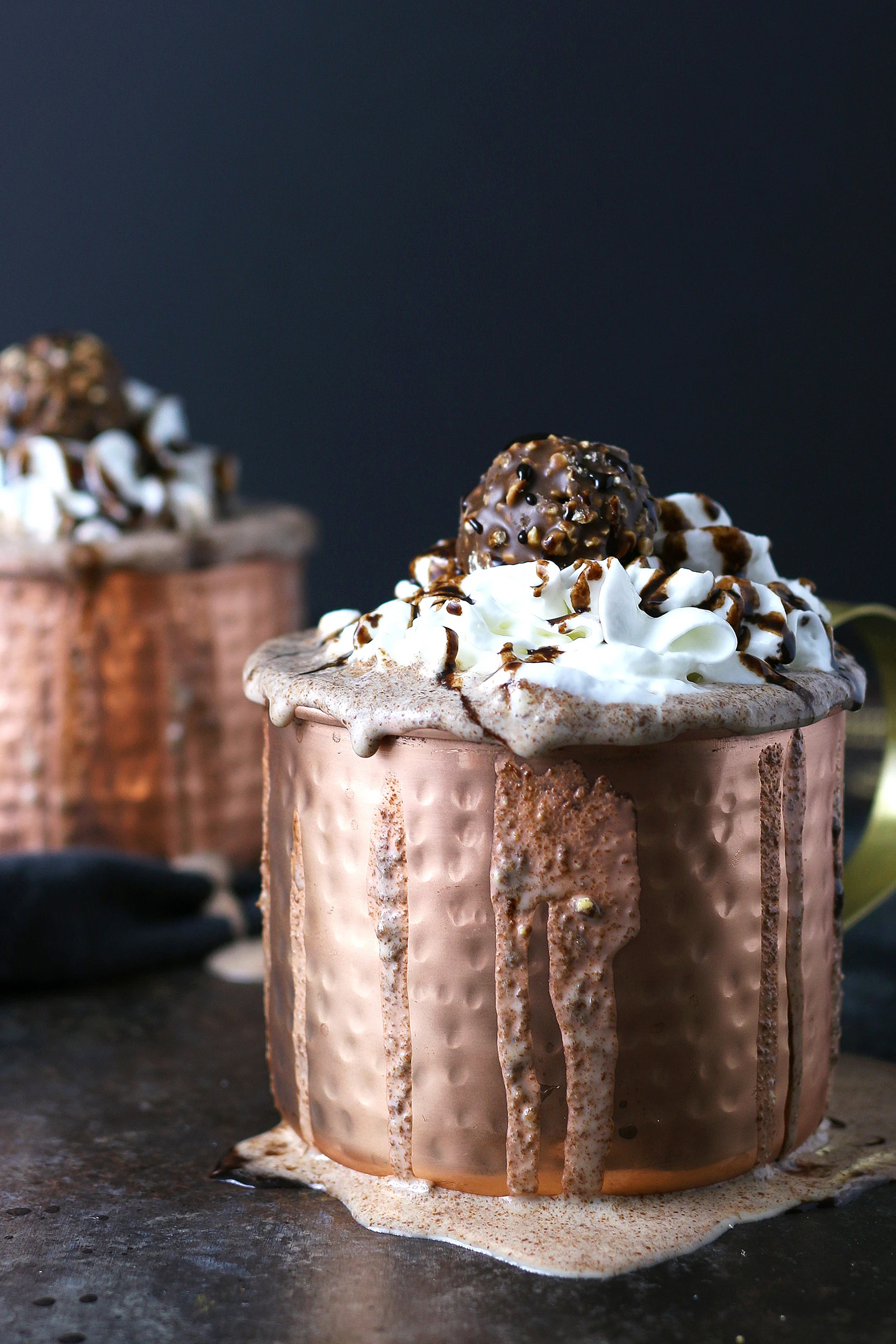 two copper mugs filled with Ferrero rocher Nutella milkshakes