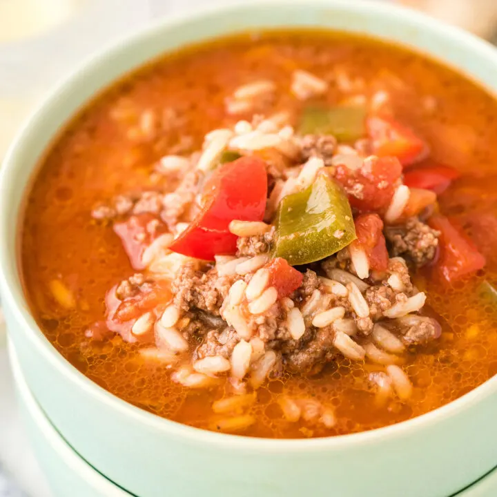 two stacked mint green bowls bowls filled with stuffed pepper soup