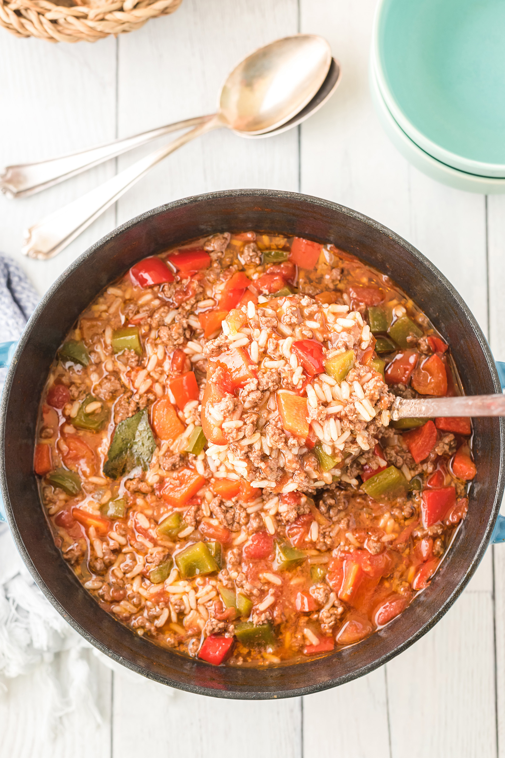 stuffed pepper soup being ladled out of the Dutch oven