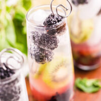 very bright photo of a blackberry kiwi mojito