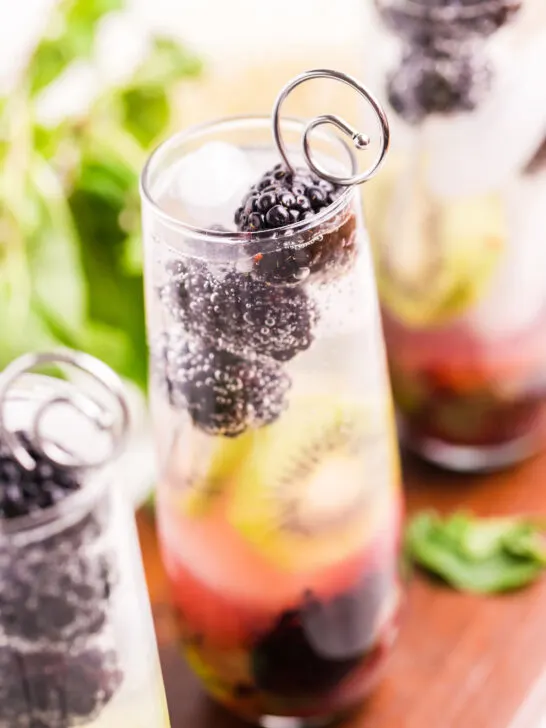 very bright photo of a blackberry kiwi mojito