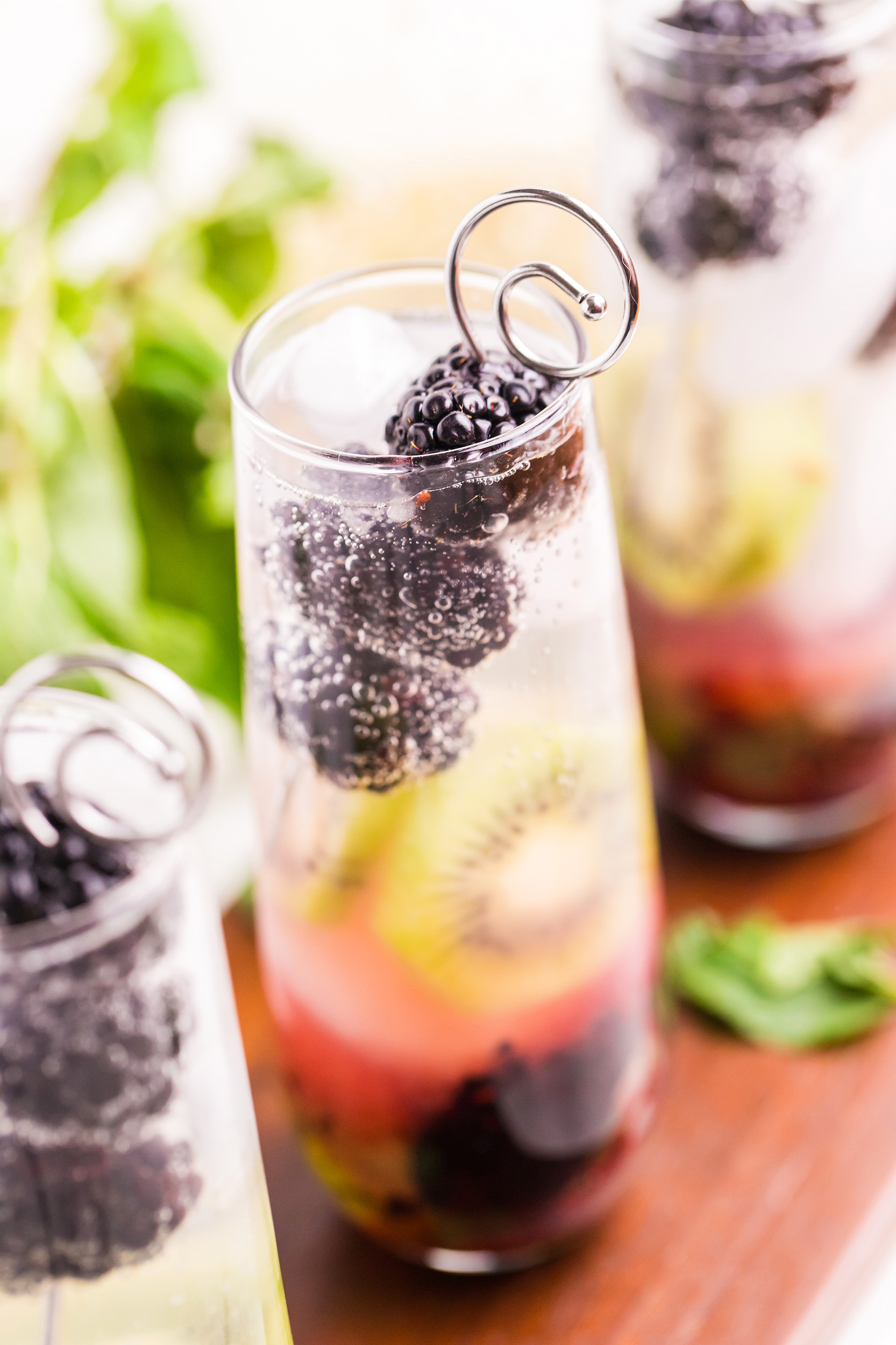 very bright photo of a blackberry kiwi mojito