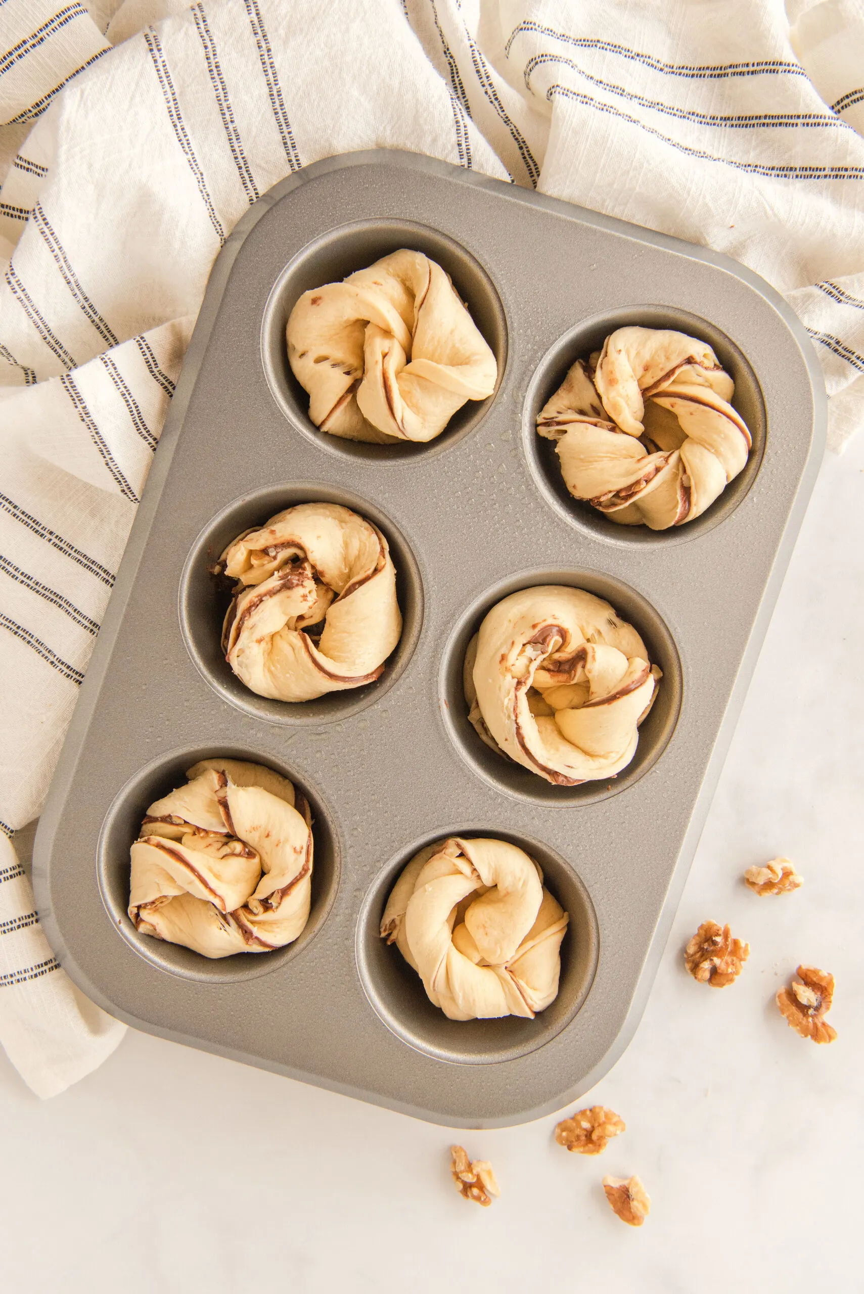 6 uncooked Nutella muffins ready to go in the oven