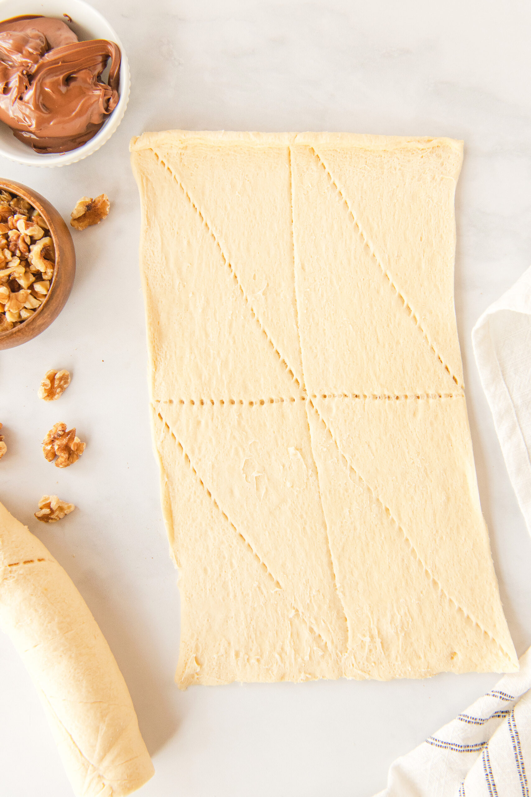 one package of crescent roll dough spread out on a board