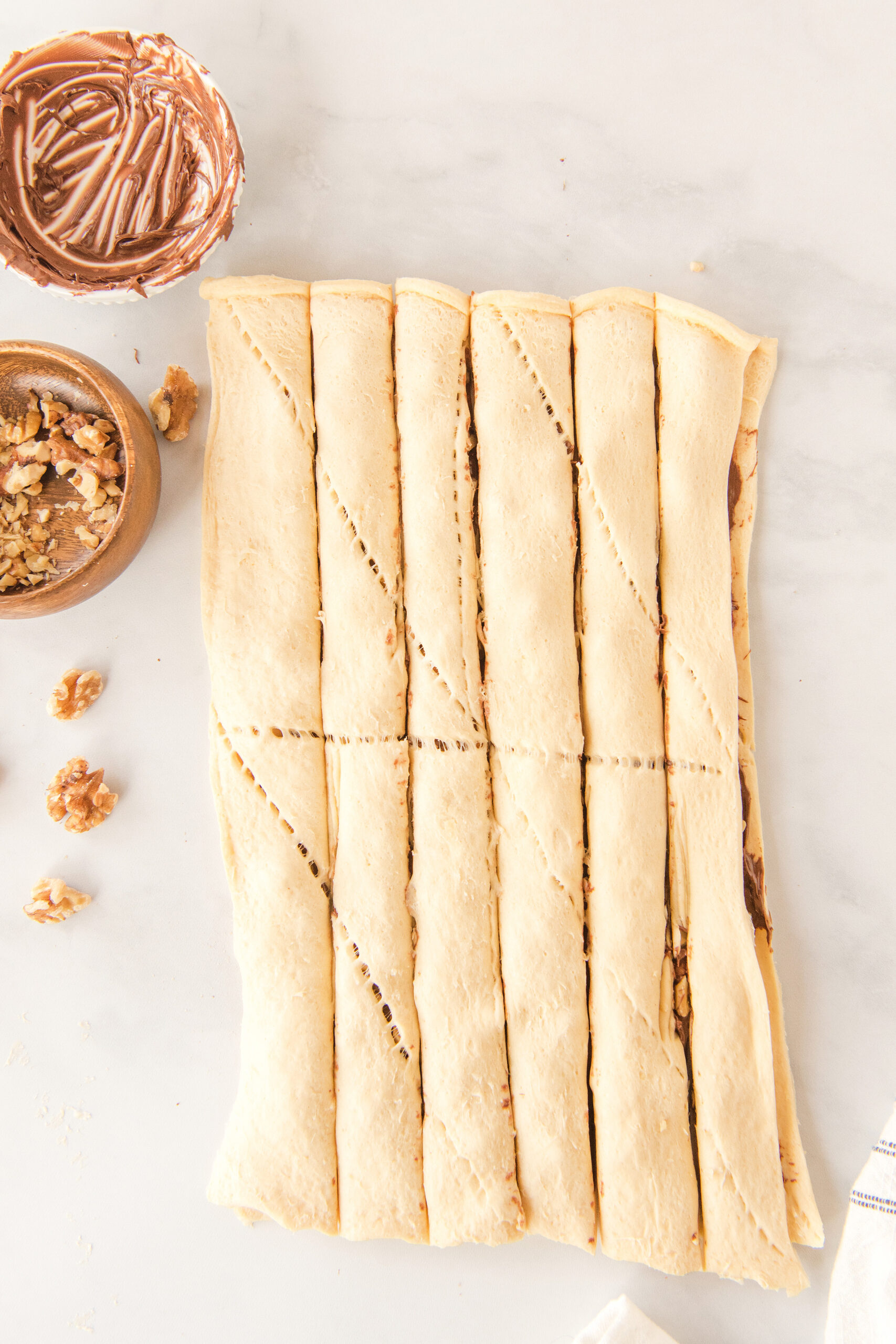 crescent roll dough filled with Nutella and walnuts cut into six strips