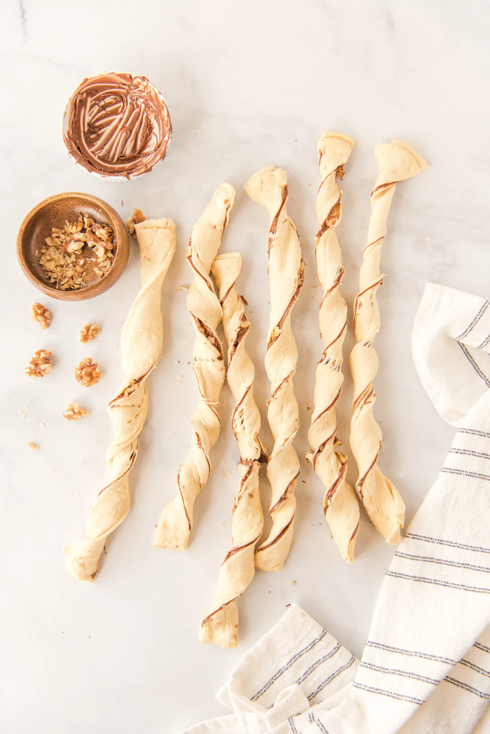 six twists of crescent roll dough filled with Nutella and walnuts